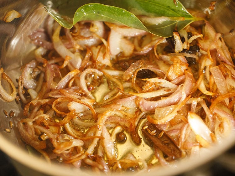 onions caramelized and golden to make vegetable pulao.