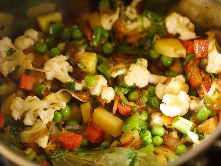 mixing the vegetables with the remaining ingredients