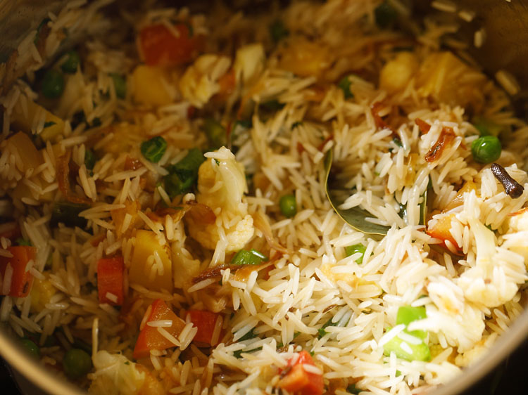 mixing rice to toast it for the pilaf.