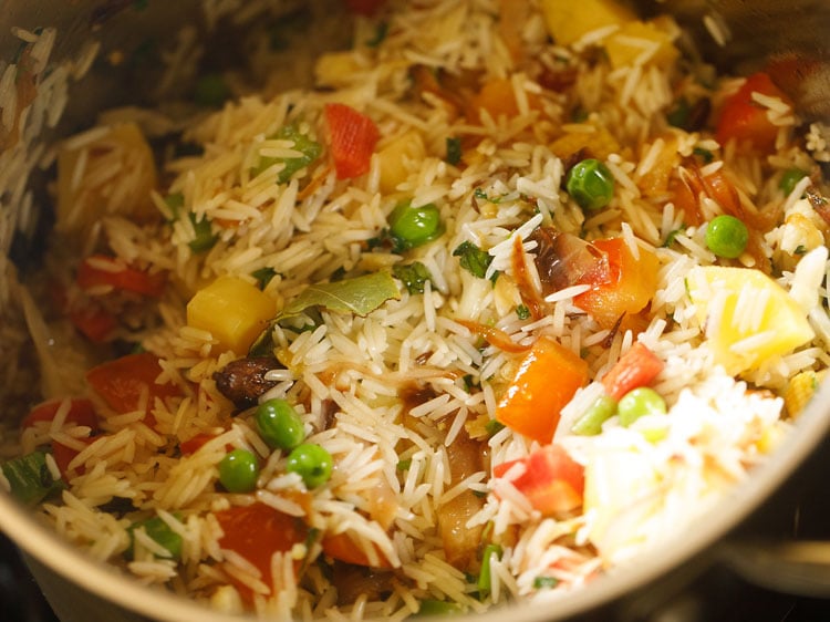 mixing and sautéing rice for 1 to 2 minutes