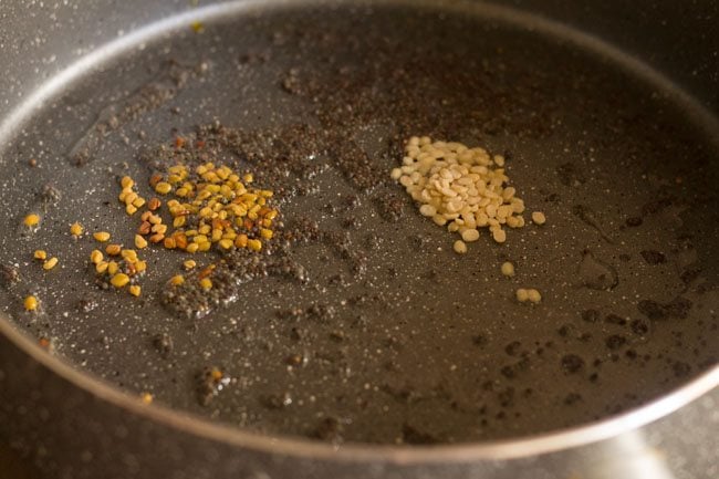 adding fenugreek seeds and urad dal to oil