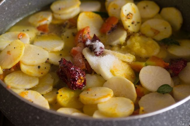 adding salt as required to pan