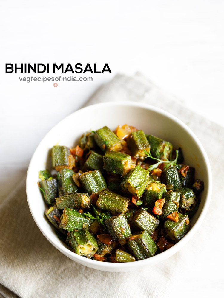 bhindi masala in a white bowl on a off white napkin on a white background