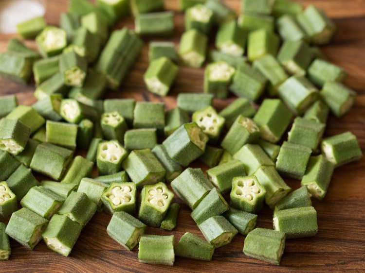 chopped bhindi on a chopping board for making bhindi masala recipe. 