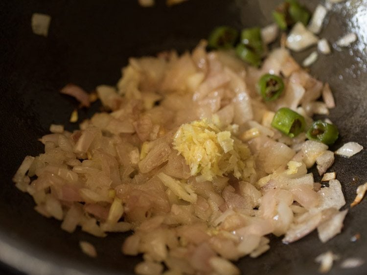 ginger garlic paste and chopped green chilies added to pan for making bhindi masala recipe. 