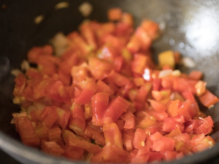 chopped tomatoes added to the pan. 