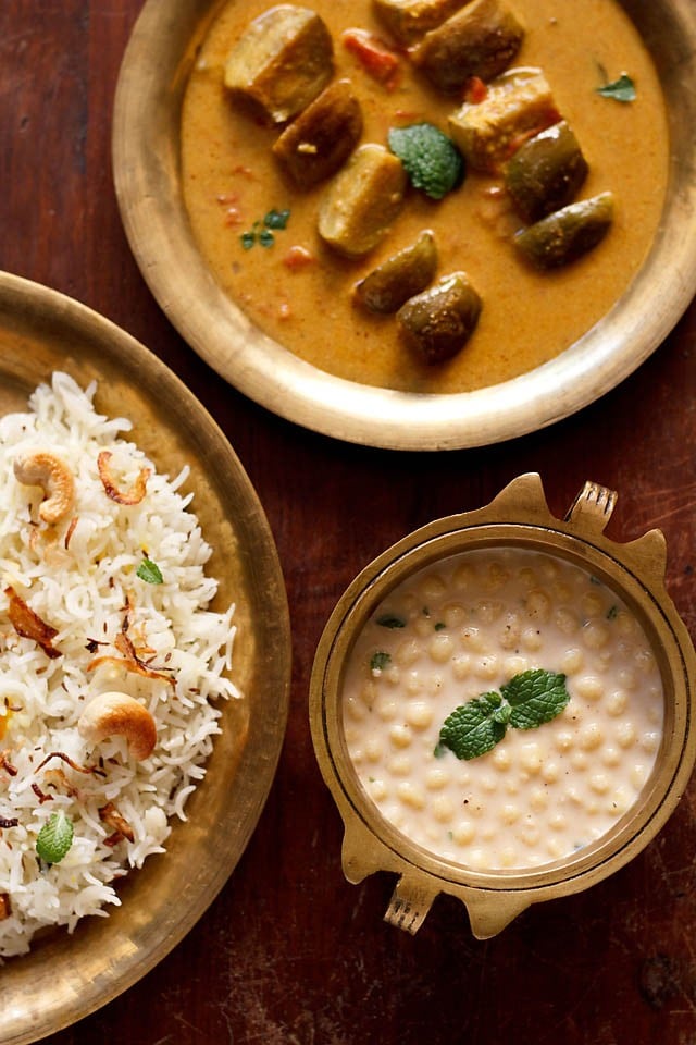 boondi raita served in a bowl with a side of rice and brinjal curry