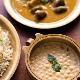 boondi raita served in a bowl with a side of rice and brinjal curry.
