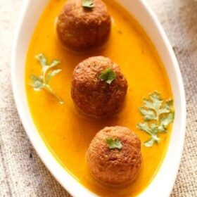 lauki kofta garnished with coriander leaves and served in a white dish.