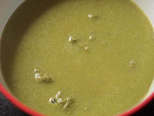 adding water to jaljeera chutney in a bowl