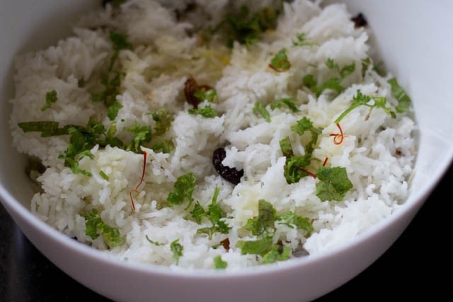 adding chopped mint, chopped coriander leaves, saffron water and oil to the bowl