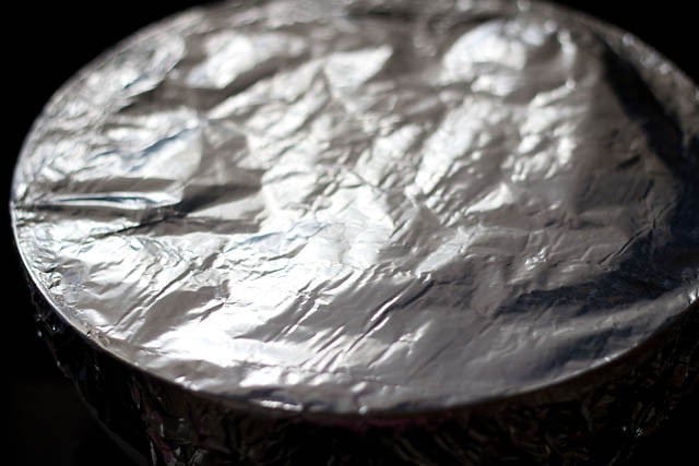 repeat the layers once again, cover the bowl with an aluminium foil and bake 