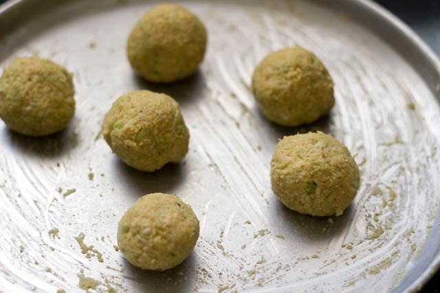forming small sized round or oval balls of lauki mixture to make lauki ke kofte.
