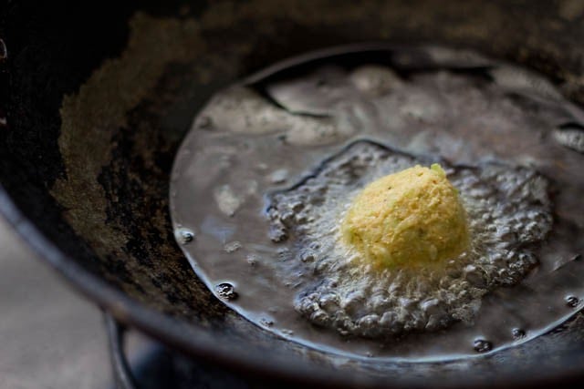 frying lauki kofta balls in hot oil.