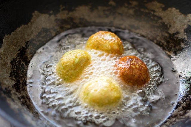 frying lauki ke kofta balls in hot oil.