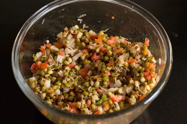 mixing all the sprouts salad ingredients in bowl