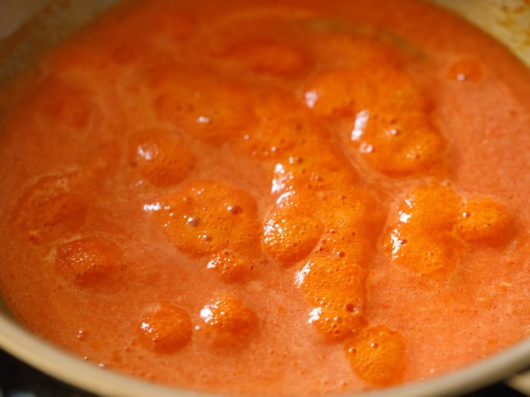 tomato puree getting simmered in the pan