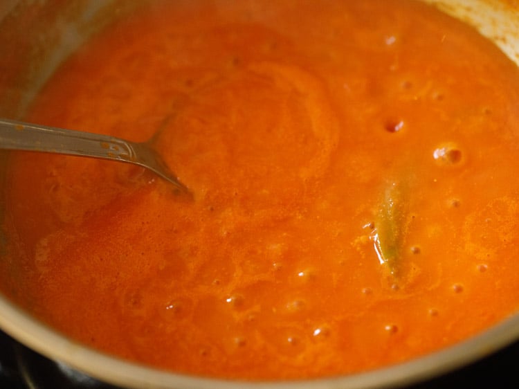 stirring tomato puree