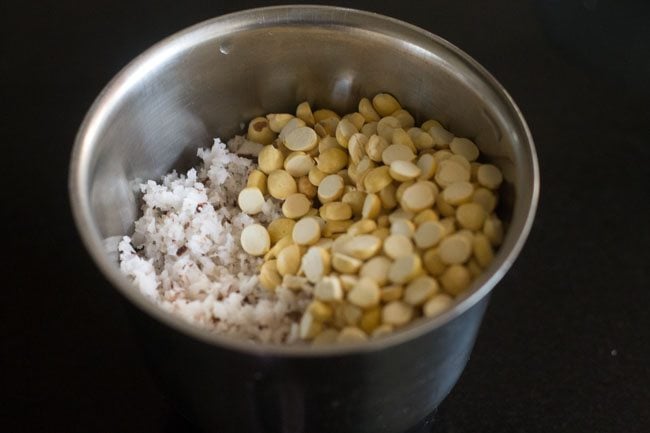 adding grated coconut and roasted Bengal gram in grinder jar