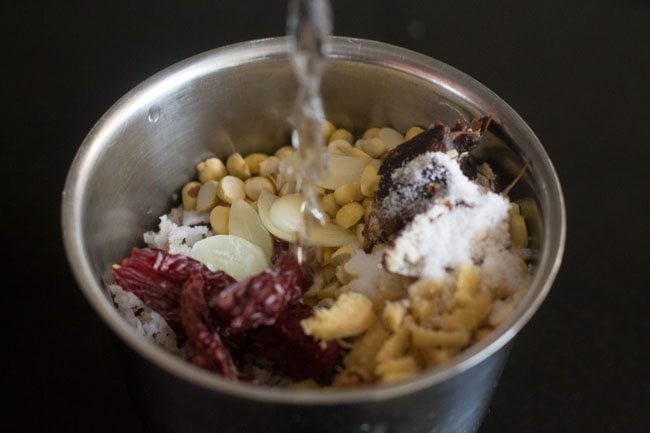 adding water in grinder jar 