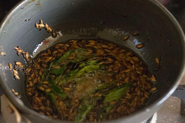 frying ingredients in hot oil for tempering red chilli chutney