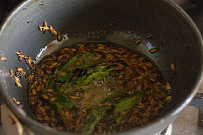 frying ingredients in hot oil for tempering red chilli chutney