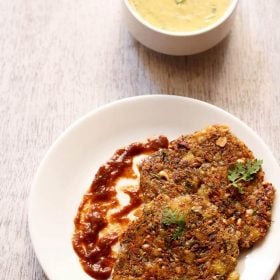 The sabudana thalipeeth is served on a white plate.