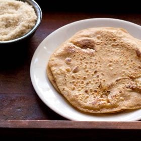 sweet paratha served on a white plate.