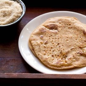 sugar paratha served on a white plate