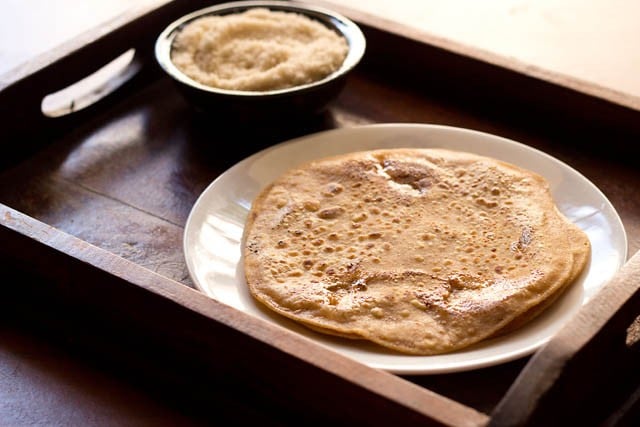 sugar paratha served on a white plate