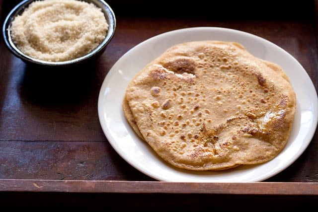 sweet paratha served on a white plate.