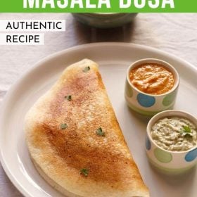 mysore masala dosa served on a plate with a small bowl of garlic chutney and a small bowl of coconut chutney and text layovers.