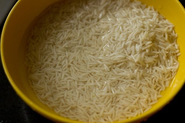 soaking basmati rice in a bowl to make biryani rice