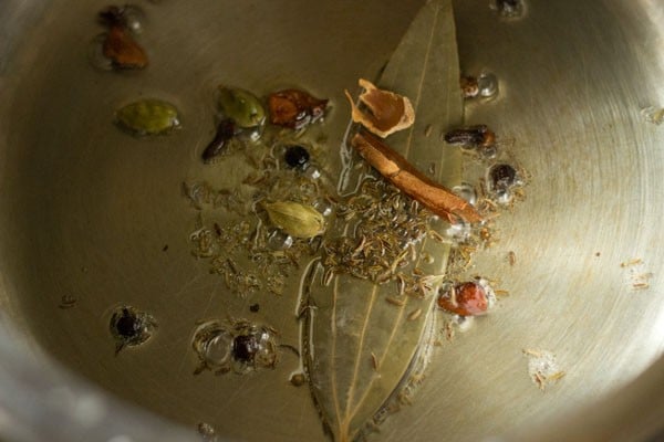 frying spices in oil in a pressure cooker