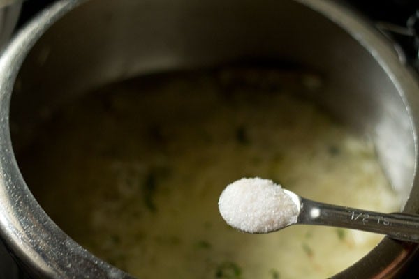 adding salt to the biryani rice mixture