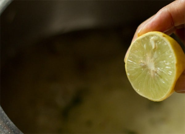 adding lemon juice to biryani rice mixture