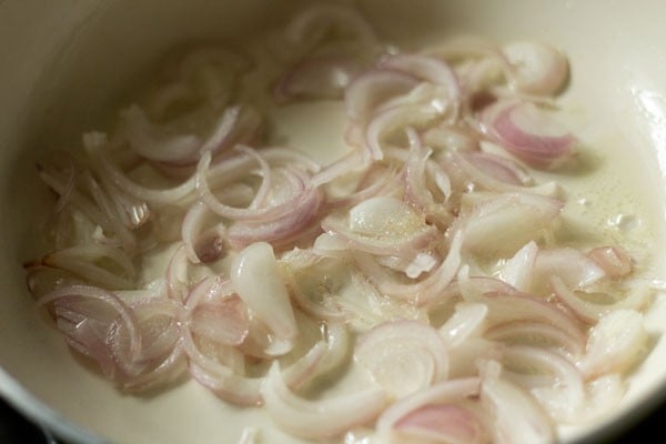 adding salt to onions and sautéing onions 