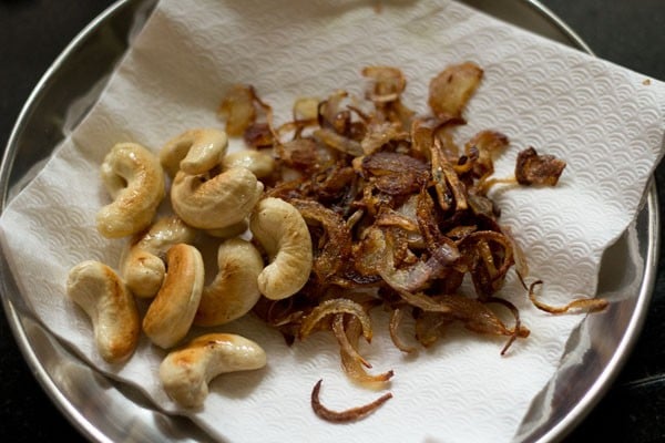 draining fried cashewnuts on kitchen paper towels