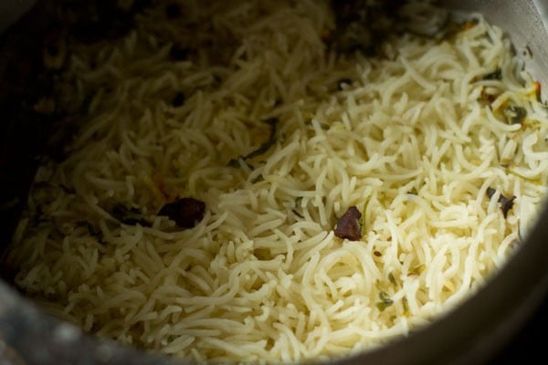fluffing the biryani rice after pressure has fallen 