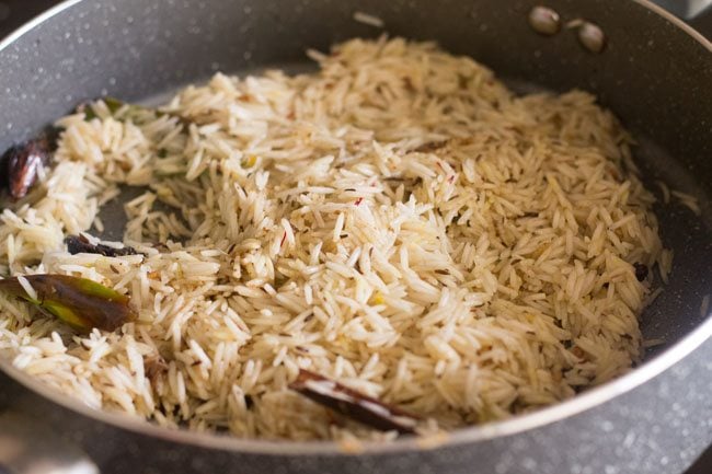 sautéing rice and spices for Kashmiri pulao recipe