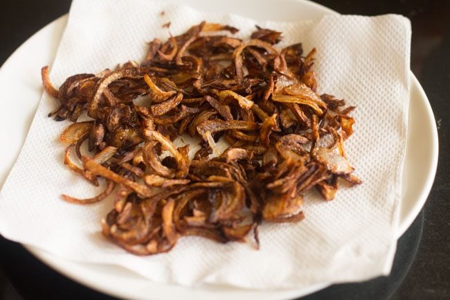 draining fried onions on paper towels
