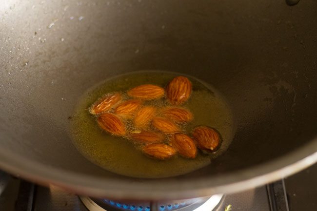 whole almonds added to pan with oil to fry