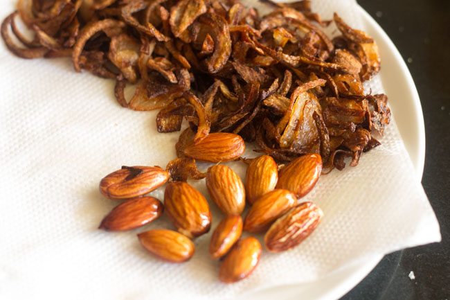 fried almonds on paper towel to drain