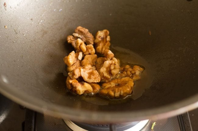 walnuts added to pan with oil to fry