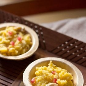 mango halwa in two areca leaf bowls on a brown wooden tray,