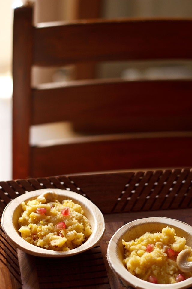 mango halwa garnished with fresh pomegranate arils and served in wooden bowls. 