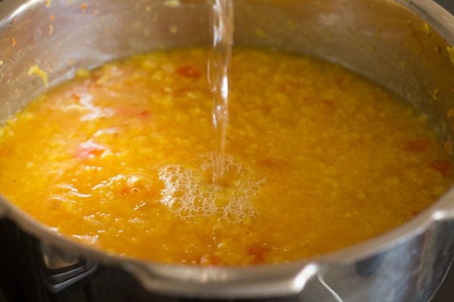 water being added to cooked moong dal