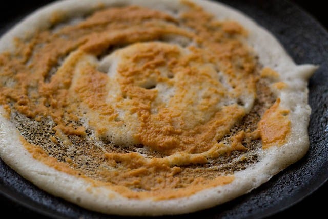 red chutney spread all over on the dosa. 