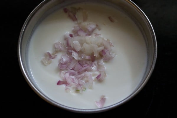 adding chopped onions to curd