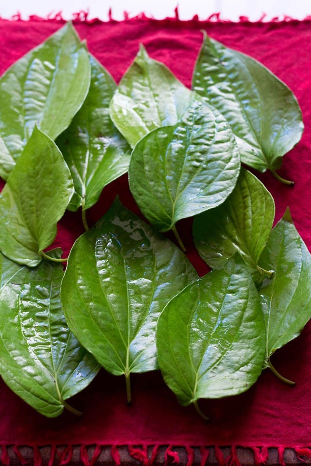 fresh paan leaves on  a red napkin.